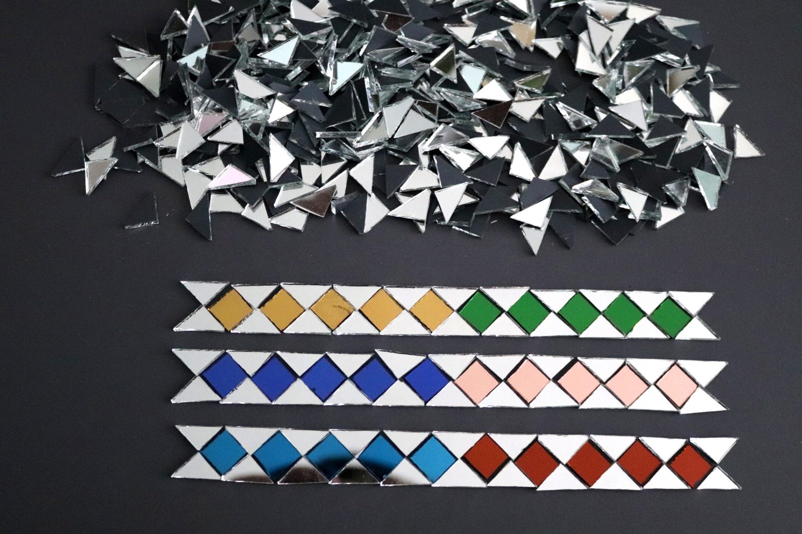 Mosaic colour mirror triangle shape approx 1 x 1 x 1.5 cm.